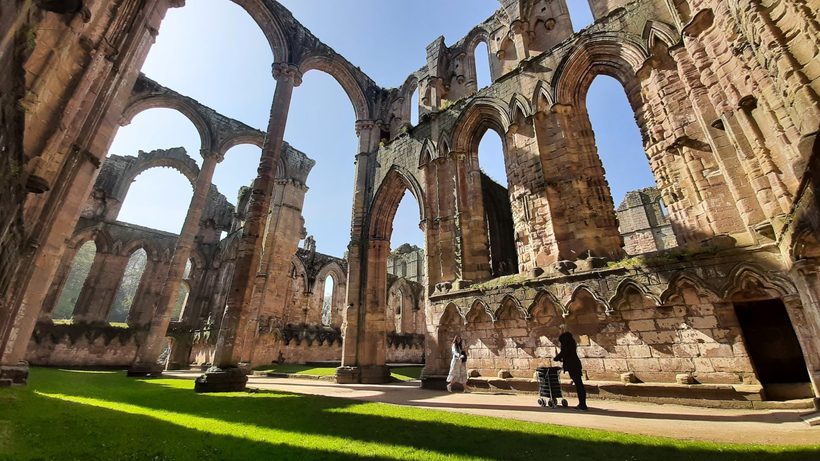 2 ladies inside Fountains Abbey ruins