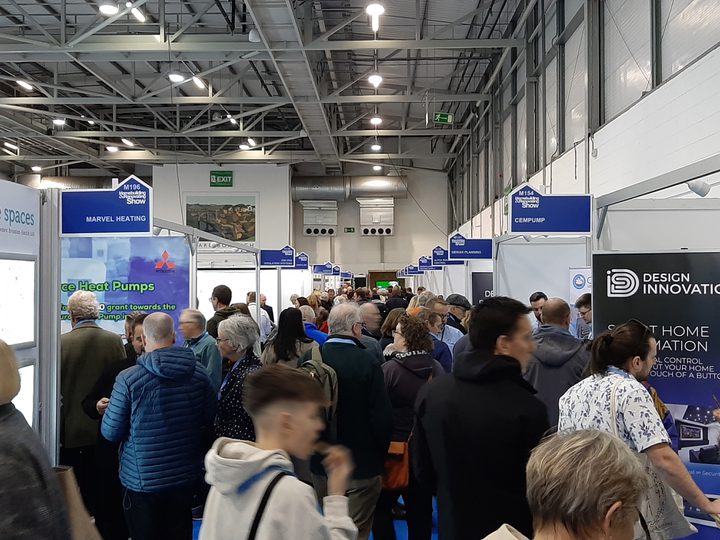 A busy exhibition hall at Harrogate Convention Centre with lots of stands and visitors