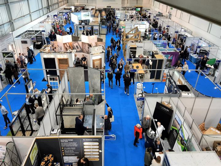Aerial view of a large exhibition hall filled with exhibition stands and visitors