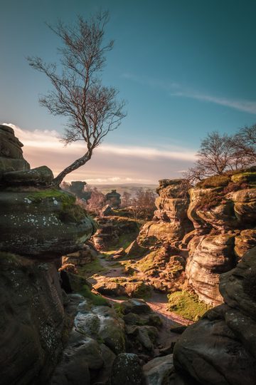 A gorge at dusk with towering rock formations on both sides